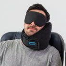 Traveler using the Airze Eze Sleep Bundle with a black travel pillow and blackout sleep mask, providing neck support and ultimate travel comfort.